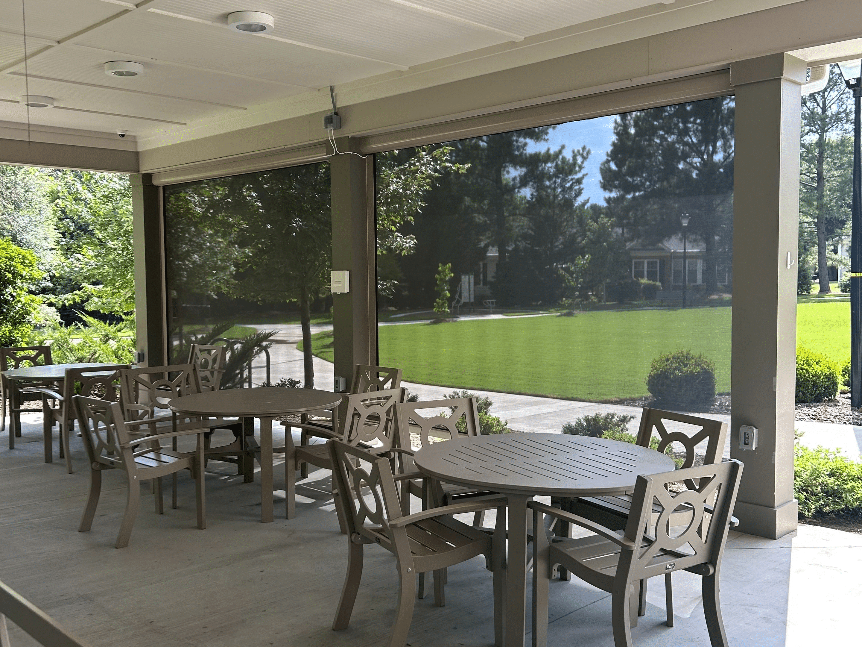 Exterior shades filtering in natural light to an outdoor seating area.